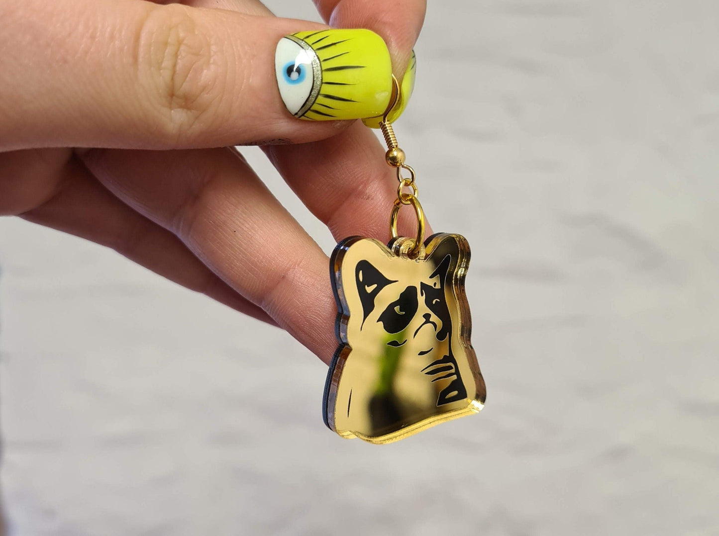 Grumpy Cat meme earrings.